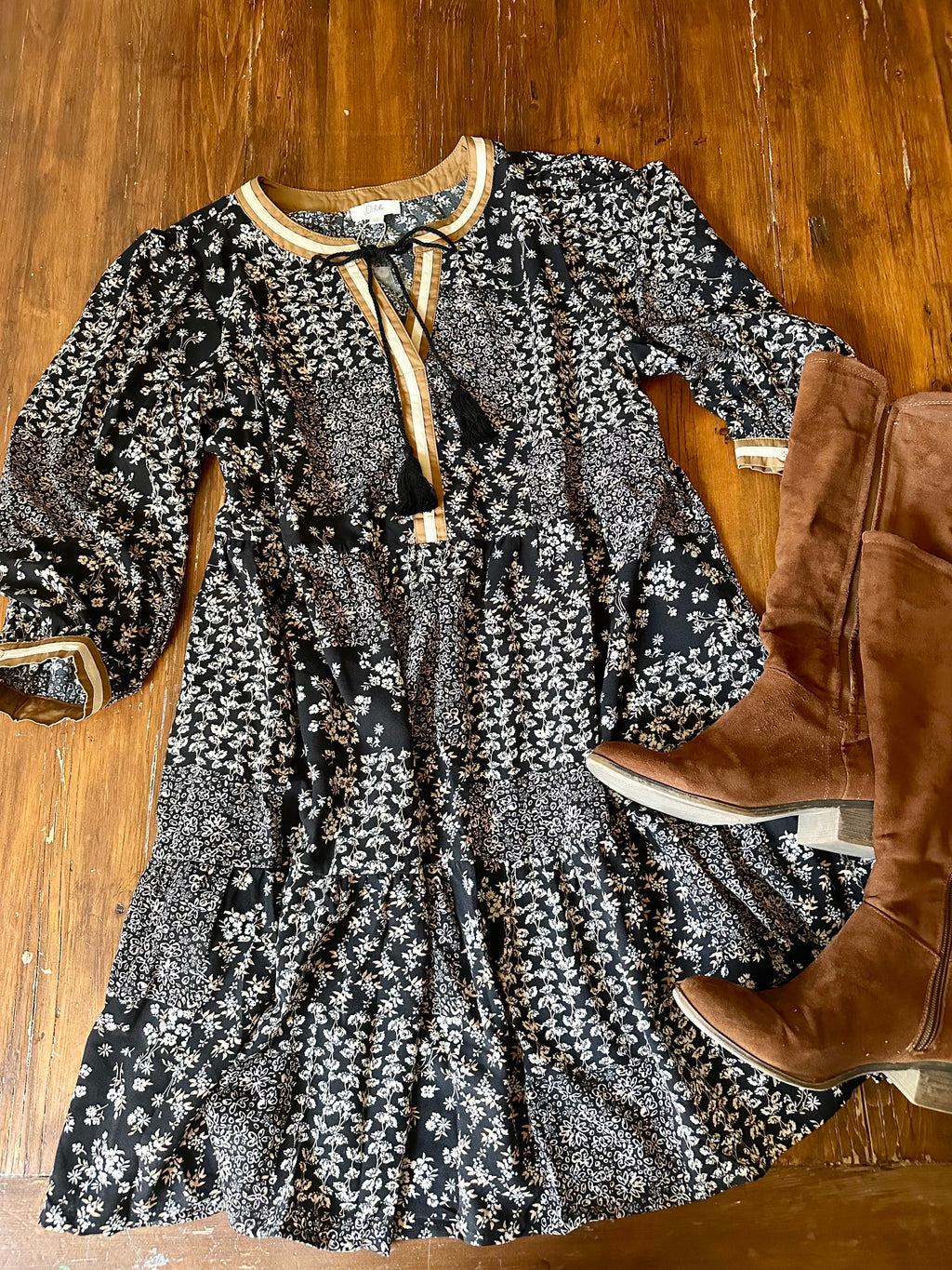 Ditsy Floral Printed Dress with 3/4 sleeves and pockets, styled with brown suede knee-high boots in a flat-lay style. Flowy fit ideal for fall fashion.