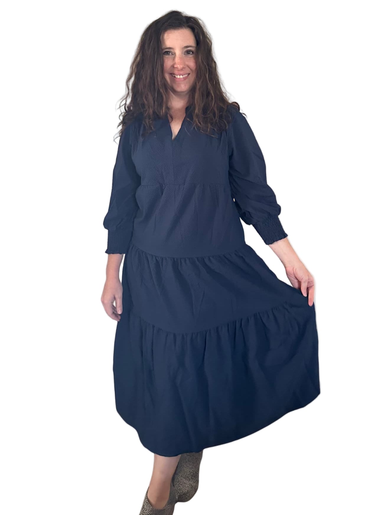 Woman wearing a navy blue dress on a white background